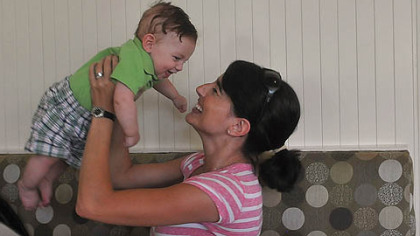 Melissa Bowman keeps her son Cameron, 4 months, occupied while she has brunch with her husband Karl and their daughter Emma at The Porch at Schenley.