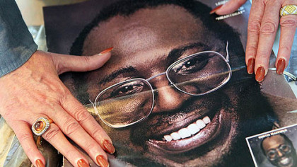 Curtis Mayfield's widow, Altheida Mayfield, flips through old family albums of her late husband in Atlanta.