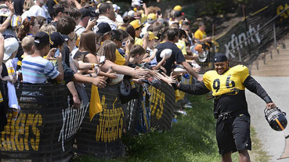 Ziggy Hood high fives fans on his way to afternoon workouts at training camp at Saint Vincent College.
