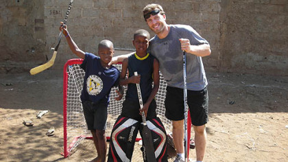 Penguins center Joe Vitale hangs out with two Haitian boys during a game of street hockey at the EBAC orphanage.