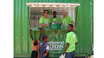 Penguins winger Matt Cooke, left, and Penguins center Joe Vitale, right, help operate a newly opened recycling center on their trip to Haiti.
