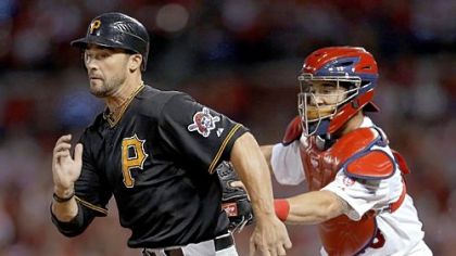 Garrett Jones, left, is tagged out by St. Louis Cardinals catcher Tony Cruz after being caught between third and home in the fourth inning Friday in St. Louis.