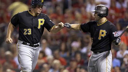 Travis Snider, left, is congratulated by Michael McKenry after scoring on a wild pitch by Cardinals starter Jake Westbrook during the fourth inning Friday night in St. Louis.
