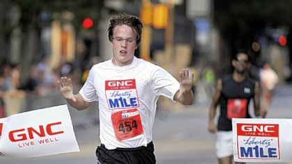 Eric Rauterkus of the South Side wins the recreational mile in 5:21 at the GNC Live Well Liberty Mile race Friday night, which started in the Strip District and ended Downtown.