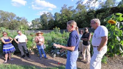 Gardeners listen as Sandy Feather of Penn State speaks at a Pittsburgh community garden.