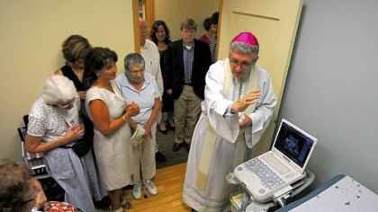 Bishop David Zubik blesses the ultrasound machine Thursday at the North Side office of Women's Choice Network.