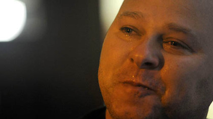 Clairton police Officer James Kuzak tears up while speaking to supporters in the courtyard of the Allegheny County Courthouse on Friday.