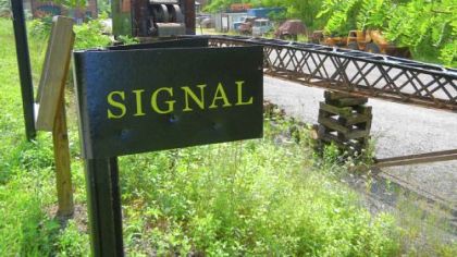 Old signs tell some of the story of the railroad and coal mines the trail served. Between miles 29 and 30 is an impressive example of rolling stock. The X1 crane was built in 1947 and remained in service until the railroad ceased operations in the early 1980s.