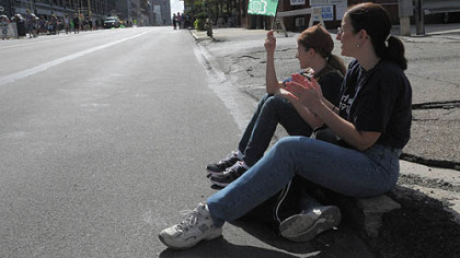 After the Girl Scouts 100th anniversary parade,  Caelyn Allen, 7, of Brownies Troop 50597, North Side, waits with her group on the Boulevard of the Allies, Downtown.