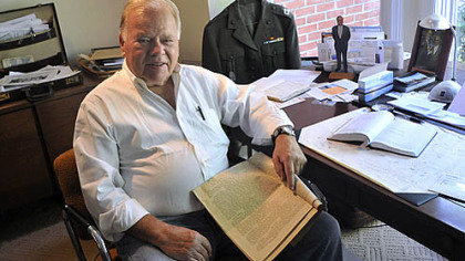 William Patterson, at home in Shadyside, holds Fulton County newspapers from the early 20th century.