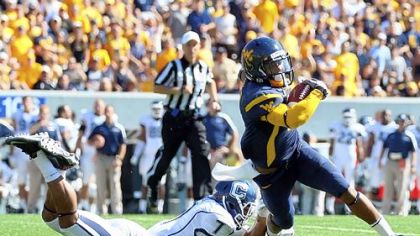 West Virginia's dazzling receiver Tavon Austin, seen here gaining yardage against Connecticut, is helping young and undersized Jordan Thompson follow in his footsteps.