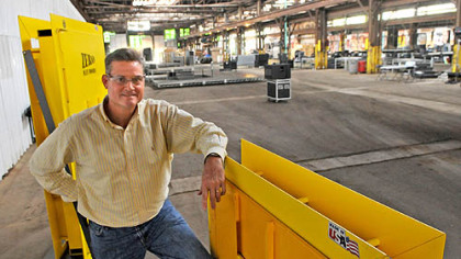 Beaver Steel Services President Tony Treser stands with two types of mining doors made at the plant in Rosslyn Farms. The warehouse is where the Mitt Romney campaign will hold a rally Tuesday with vice presidential candidate Paul Ryan.