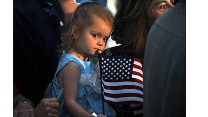 A girl holds an American flag during a rally for Paul Ryan today.