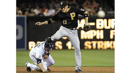 the Pirates' Clint Barmes jumps over the Padres' Yasmani Grandal as he turns a double play during the third inning.