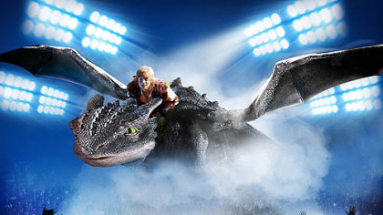 Hiccup (Rarmian Newton) and Toothless soar over enthralled fans.