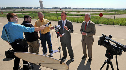 U.S. Rep. Tim Murphy (center) and Pa. Auditor General Jack Wagner (right) answer reporters' questions after a tour of the 911th Airlift Wing Air Force Reserve Base at the Pittsburgh International Airport today.