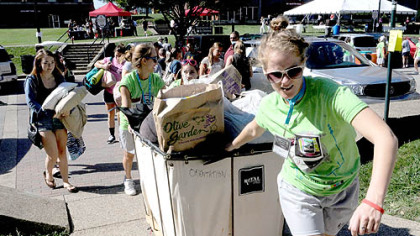 Hillary Cox, a senior at Duquesne University, lugs an incoming freshman's possessions into St. Ann Hall on Tuesday.