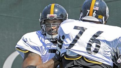 Steelers' Max Starks works with rookie Mike Adams on drills at practice Tuesday on the South Side. Starks worked with the first-team offense.