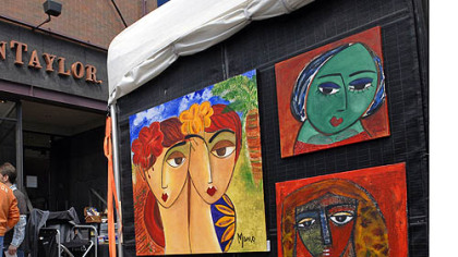 People browse the paintings at the Art Festival on Walnut Street in Shadyside.