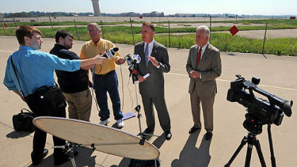 U.S. Rep. Tim Murphy, center, and state Auditor General Jack Wagner, right, answer reporters' questions after a tour of the 911th Airlift Wing Air Force Reserve Base at the Pittsburgh International Airport. The two continue to seek information from the Air Force on why the base has been selected for closure.