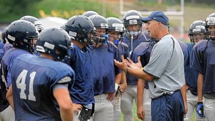 Mt. Lebanon's new head coach, Mike Melnyk, speaks to his players during a preseason practice session last Friday.
Tyler Roth throws a pass last Friday at practice.