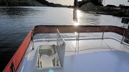 Bob Cessna goes below from the top deck of the Lydia C, the boat that he lives on with his wife, Lydia. "It?s a very uncomplicated way of living," Lydia Cessna said.