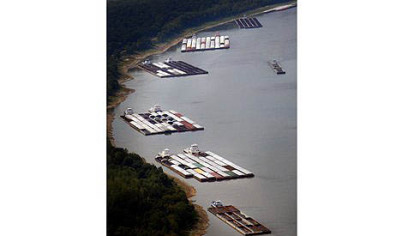Barges are stuck Tuesday near Greenville, Miss., due to low water on the Mississippi River. The tugs pushing them were waiting for dredging work to open the main channel.