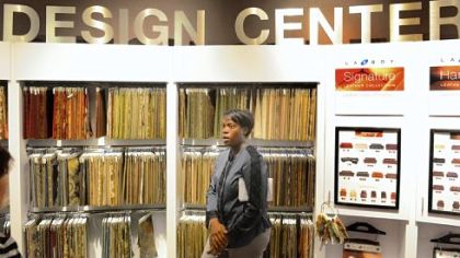 Janica Smith, manager of the new La-Z-Boy store in Monroeville, shows the many furniture fabric options in the store's design center.