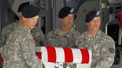 An Army carry team moves a transfer case containing the remains of Staff Sgt. Eric S. Holman at Dover Air Force Base, Del., Saturday, Aug. 18, 2012. According to the Department of Defense, Holman, of Evans City, Pa., died while supporting Operation Enduring Freedom in Afghanistan. (