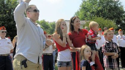 The Caskey family -- from left, Josh, Brianna, 11, Faith, 3, Kelly holding Alex, 1, and Josh Jr., 9 -- react Friday upon seeing their newly renovated home in Cranberry.