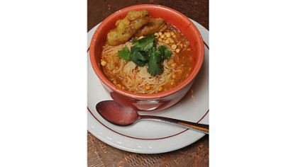 Burmese Mohinga soup ($9.50) has thin somen (wheat noodles) in fish broth with onion, garlic, lemongrass, fried chickpeas and squash fritters at Spice Island Tea House.