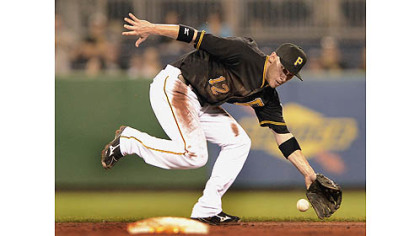 Pirates shortstop Clint Barmes can not catch up to a ball hit up the middle by the Cardinals starting pitcher Kyle Lohse for a single.