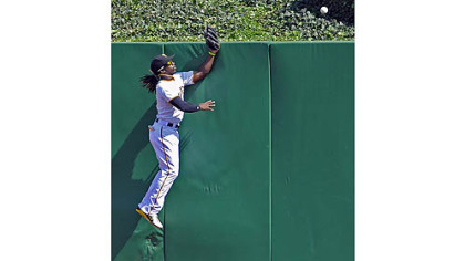 Andrew McCutchen fails to pull in a two-run home run by the Brewers' Aramis Ramirez in the fifth inning Sunday at PNC Park.