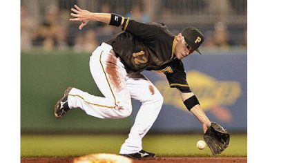 Pirates shortstop Clint Barmes can not catch up to ball hit up the middle by the Cardinals starting pitcher Kyle Lohse for a single Monday at PNC Park.