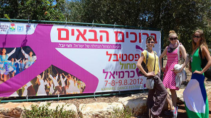 PBT dancers also had a chance to see the sights. Caitlin Peabody, left, Julia Erickson and Danielle Downey stand beside a sign announcing the Karmiel Dance Festival they performed in.