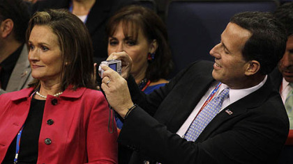 Former Pennsylvania Sen. Rick  takes a picture on Tuesday of his wife Karen during the convention.