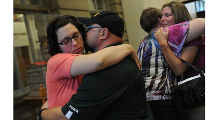 Joy Burkholder, left, receives a hug from her husband, Lance, Thursday after Melvin Knight was sentenced to death for the torture and murder of Jennifer Daugherty at the Westmoreland County Courthouse in Greensburg. Ms. Burkholder is Jennifer's sister. Heather Smitley, right, hugs Daugherty's mother, Denise Murphy.
