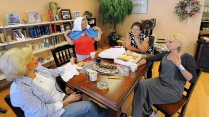 At a table filled with Mac's Donuts and Palladini chocolates, Maria Rubino, left, presides over a conclave of friends and customers -- or "family," as she calls her patrons -- in her Aliquippa beauty salon, including Marialice McElwain, fresh from a hair wash, Janet Walker, her assistant of nine-years, and Bernadette Callaghan. "I always wanted to film Maria's as a reality show," said Ms. Callaghan, a writer of children's books and non-fiction books for women.