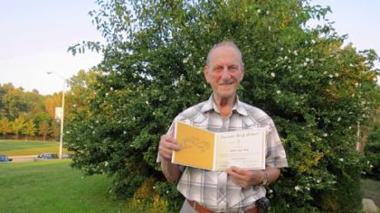Arthur Ihrig with his newly awarded high school diploma.