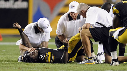 Trainers attend to Steelers rookie Sean Spence in the third quarter Thursday night at Heinz Field.