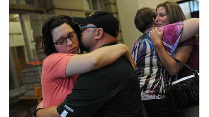 Joy Burkholder, left, receives a hug from her husband, Lance, after Melvin Knight is sentenced to death for the torture and murder of her sister, Jennifer Daugherty, Thursday at the Westmoreland County Courthouse in Greensburg. Heather Smitley, right, hugs Daugherty's mother Denise Murphy.