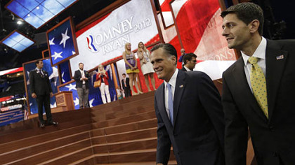 Republican presidential nominee Mitt Romney and vice presidential nominee Paul Ryan walk in for a group picture with their campaign staff at the Republican National Convention in Tampa, Fla.