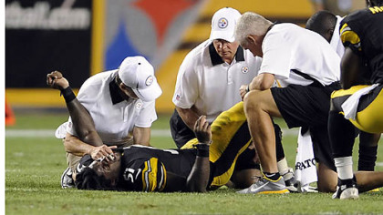 Trainers attend to Steelers rookie Sean Spence in the third quarter Thursday night at Heinz Field.