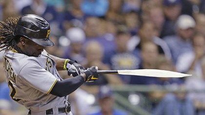 Andrew McCutchen breaks his bat during his RBI single against the Milwaukee Brewers during the eighth inning.