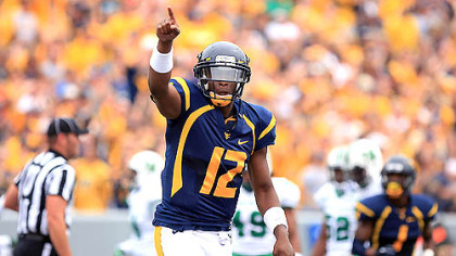 West Virginia University quarterback Geno Smith celebrates a touchdown pass against Marshall during today's game in Morgantown.