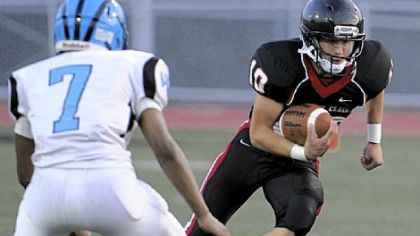 Upper St. Clair quarterback Pete Coughlin runs against Woodland Hills' Daechaud Ausbrooks in the first half Friday Upper St. Clair High School.