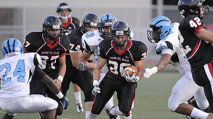 Upper St. Clair runningback Gabe Boyd rolls through Woodland Hills' defense.