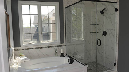 The master bath has a soaking tub, ceramic-tiled shower with heavy glass door and double-bowl sink.