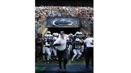Penn State head coach Bill O'Brien leads the Nittany Lions onto the field at Beaver Stadium for the season opener against Ohio University. Mr. O'Brien replaces coach Joe Paterno, who was fired in the wake of the Jerry Sandusky child sexual abuse scandal.