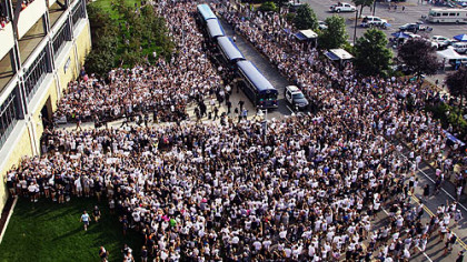 Penn State fans surround the football team as the players arrive by bus at Beaver Stadium for Saturday's season opener against Ohio University.
